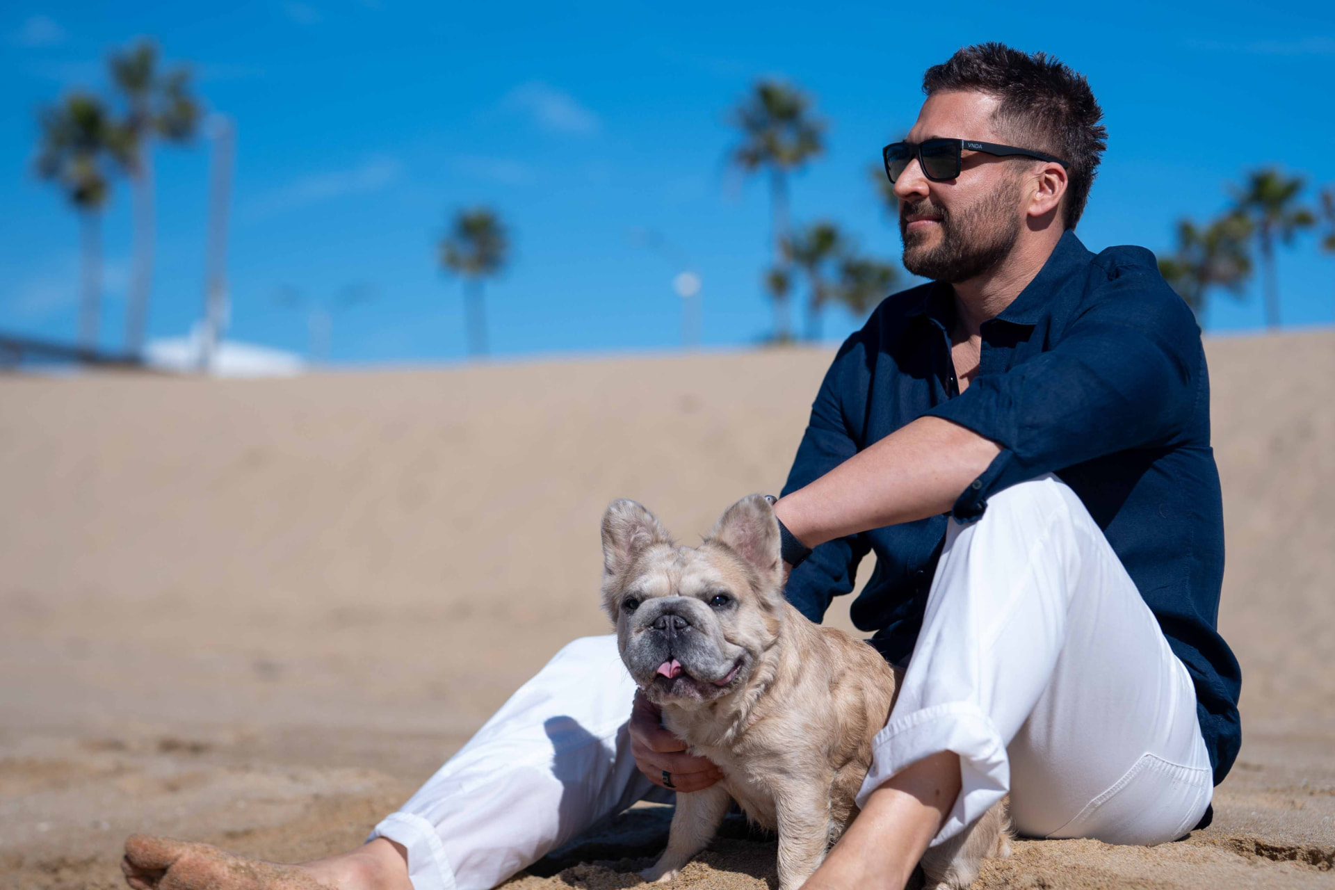 Neil Anders with his dog beside the Pacific